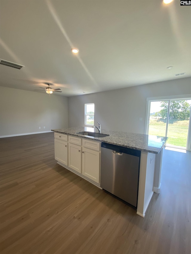 kitchen with visible vents, a sink, stainless steel dishwasher, dark wood finished floors, and white cabinetry