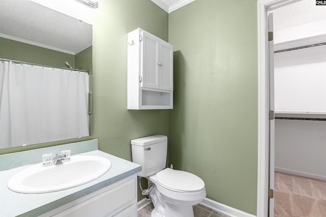 full bath with vanity, baseboards, a textured ceiling, crown molding, and toilet