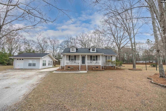 view of front facade featuring a porch, a garage, an outdoor structure, crawl space, and driveway