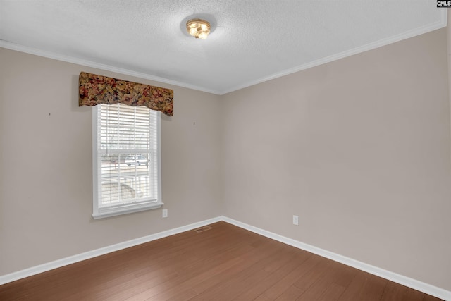 empty room featuring visible vents, baseboards, dark wood-type flooring, and a textured ceiling