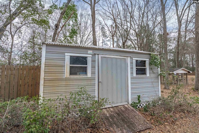 view of shed featuring fence