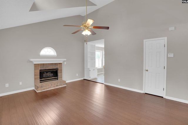 unfurnished living room featuring baseboards, a fireplace, wood finished floors, and a ceiling fan