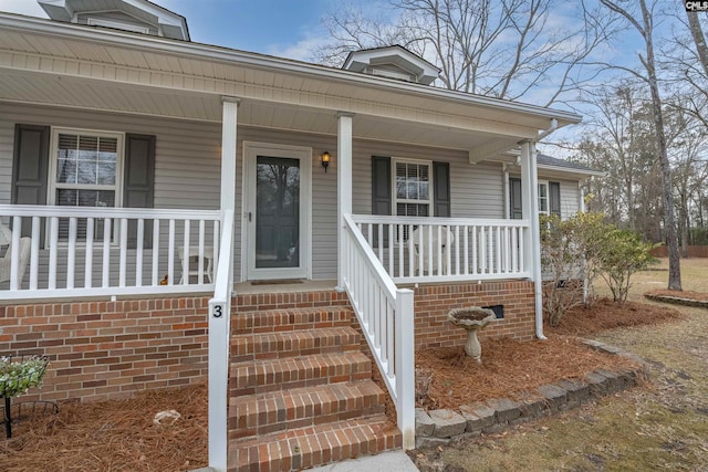 doorway to property with a porch