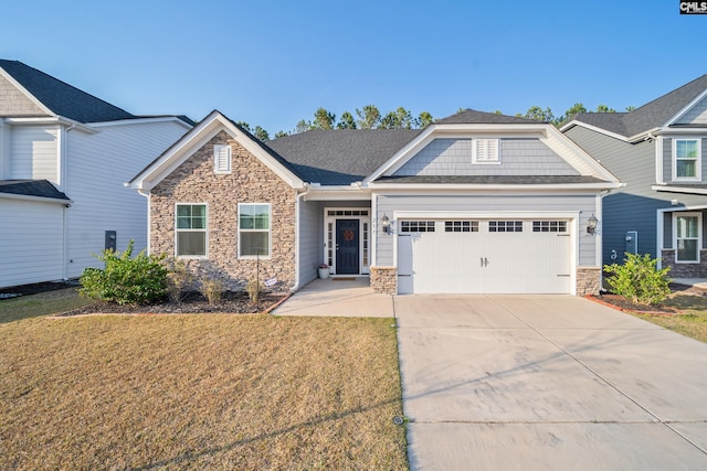 craftsman-style house featuring driveway, stone siding, a front lawn, and an attached garage