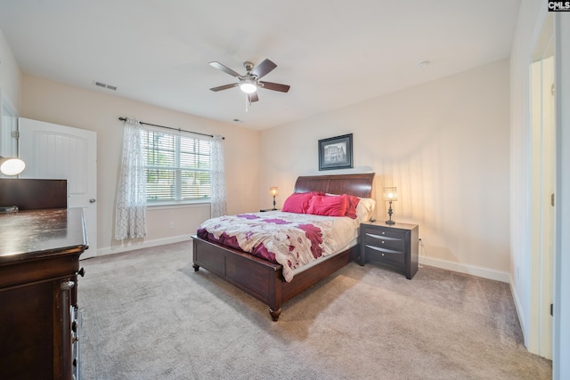 carpeted bedroom featuring visible vents, a ceiling fan, and baseboards