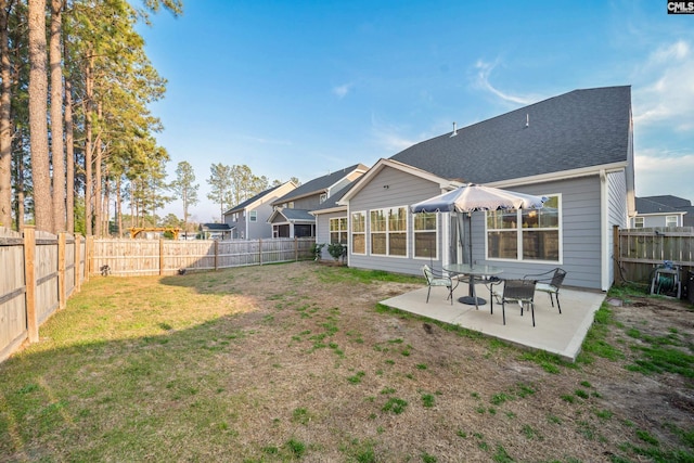 back of property featuring a patio area, a lawn, and a fenced backyard