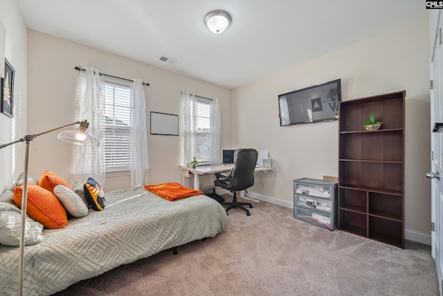 carpeted bedroom with visible vents and baseboards