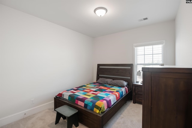 bedroom with visible vents, baseboards, and light colored carpet