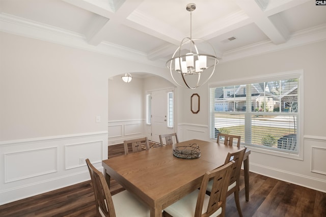 dining area featuring beam ceiling, arched walkways, dark wood-style flooring, and a chandelier