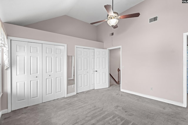 unfurnished bedroom with baseboards, visible vents, two closets, and carpet floors