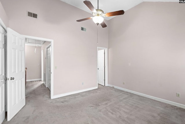 unfurnished bedroom featuring visible vents, high vaulted ceiling, attic access, and carpet flooring