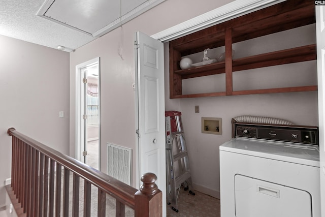 laundry room featuring visible vents, baseboards, attic access, laundry area, and washer / clothes dryer