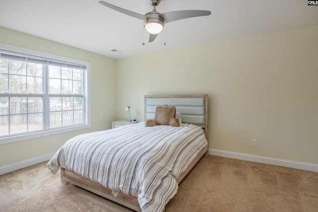 bedroom with visible vents, baseboards, carpet floors, and ceiling fan