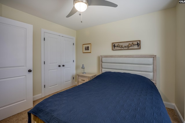 carpeted bedroom with a ceiling fan, baseboards, and a closet