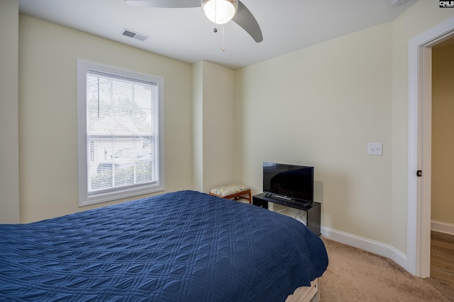 carpeted bedroom with baseboards, visible vents, and ceiling fan