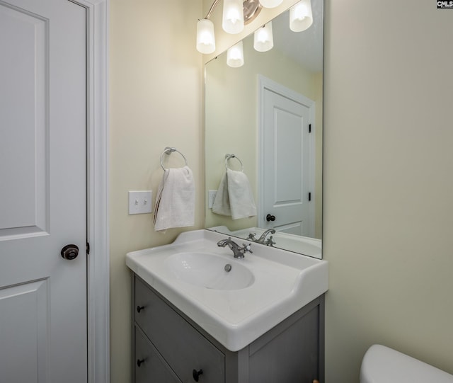 bathroom featuring toilet and vanity