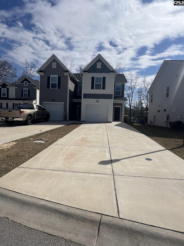 view of front facade with concrete driveway, an attached garage, and a residential view