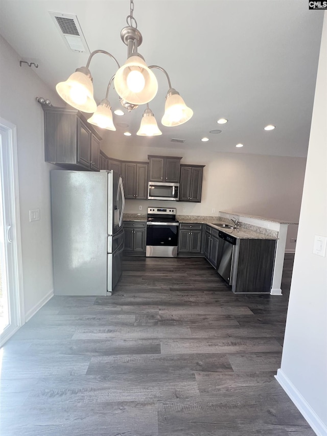 kitchen featuring visible vents, a sink, dark wood finished floors, appliances with stainless steel finishes, and baseboards