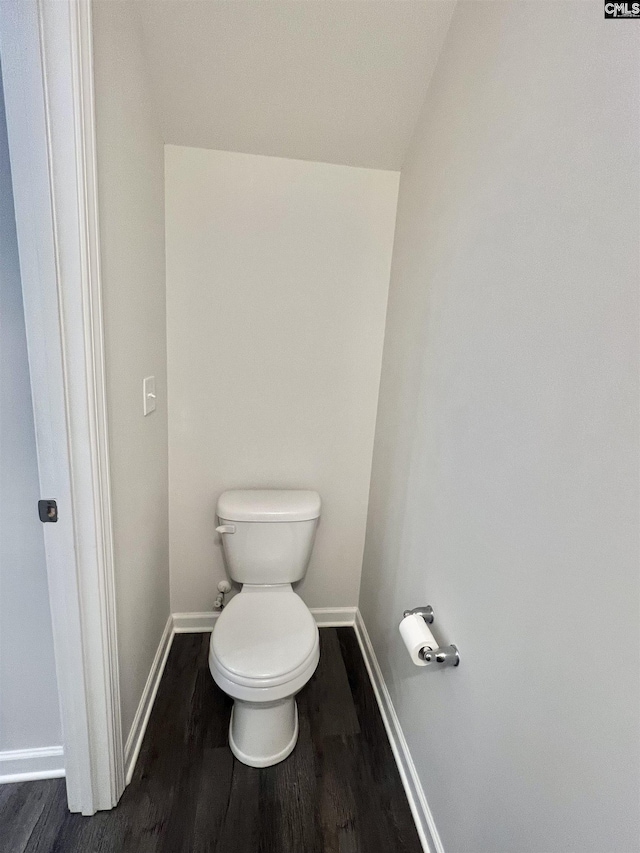 bathroom with baseboards, toilet, and wood finished floors