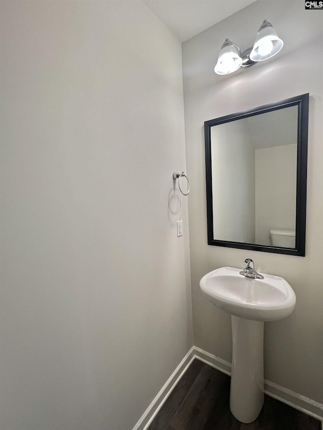 bathroom with wood finished floors and baseboards