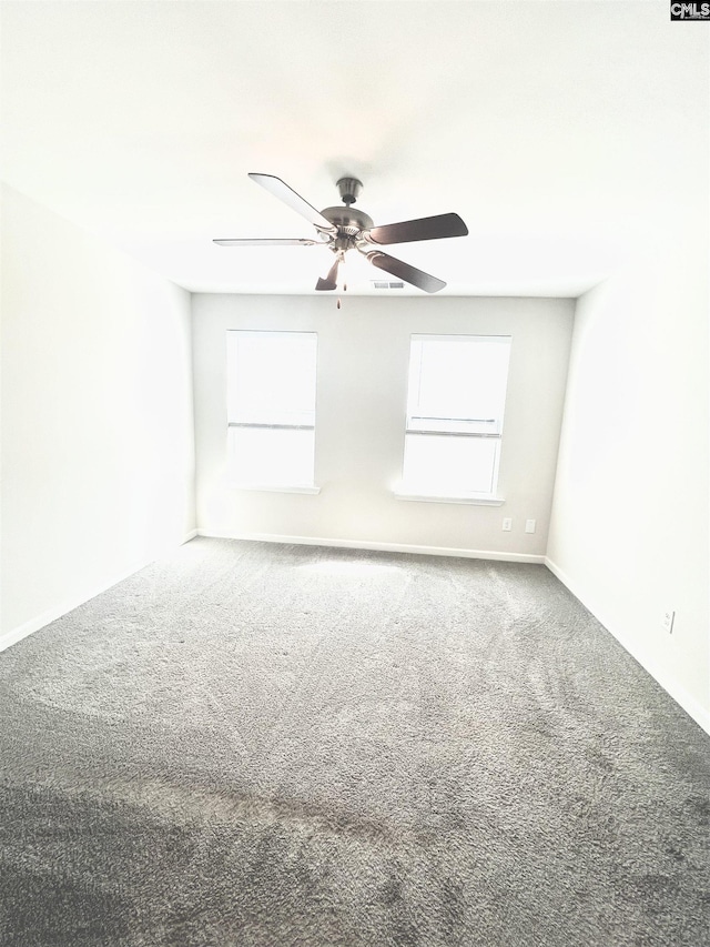 spare room featuring a healthy amount of sunlight, carpet, and ceiling fan