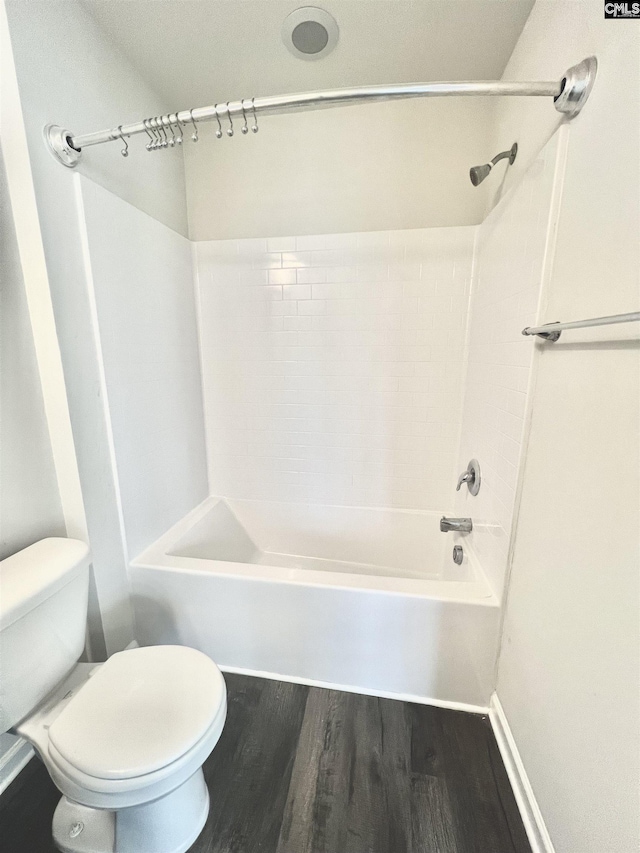 bathroom featuring shower / bathing tub combination, toilet, and wood finished floors