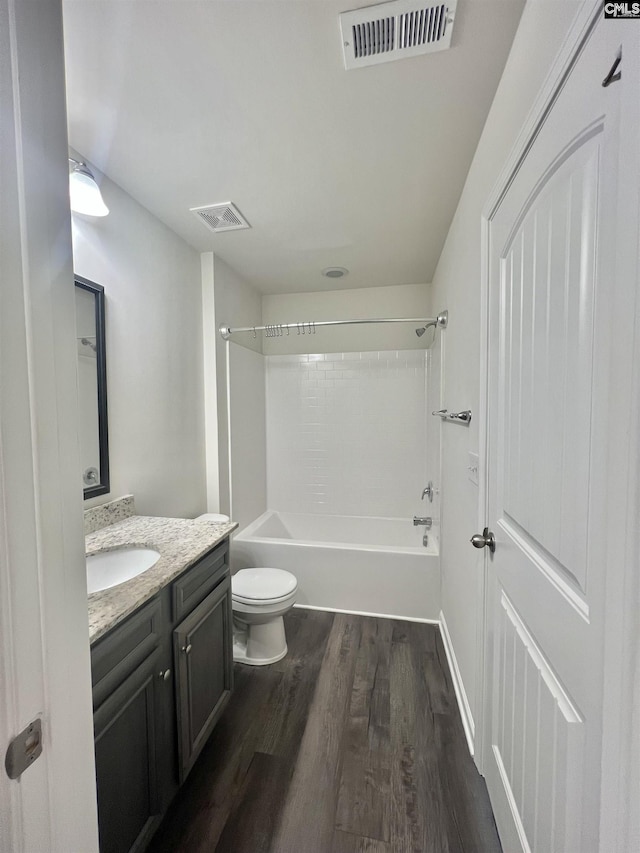 full bathroom with visible vents, toilet, vanity, and wood finished floors