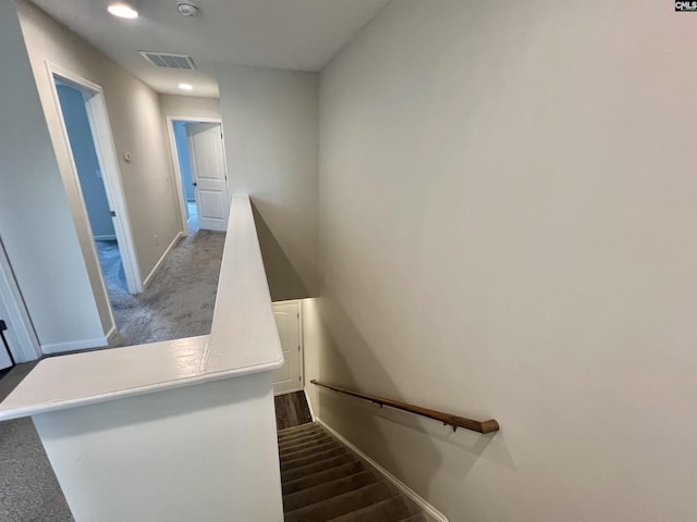 stairs featuring visible vents, baseboards, and wood finished floors