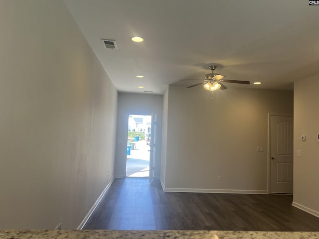 empty room with dark wood-type flooring, recessed lighting, a ceiling fan, and baseboards