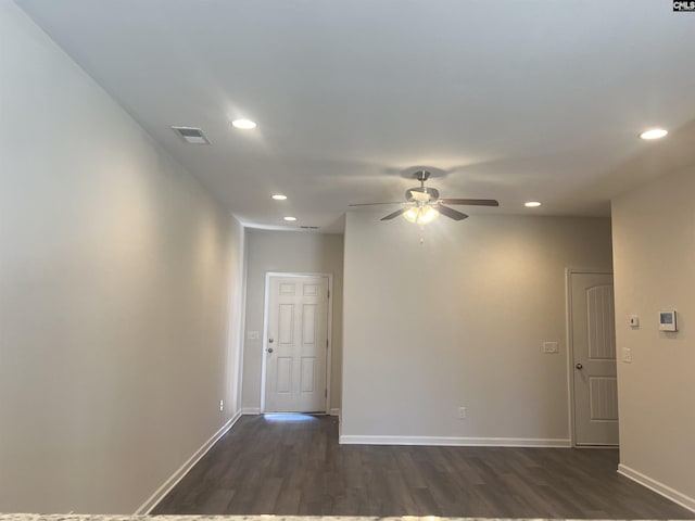 unfurnished room with visible vents, dark wood-type flooring, a ceiling fan, recessed lighting, and baseboards