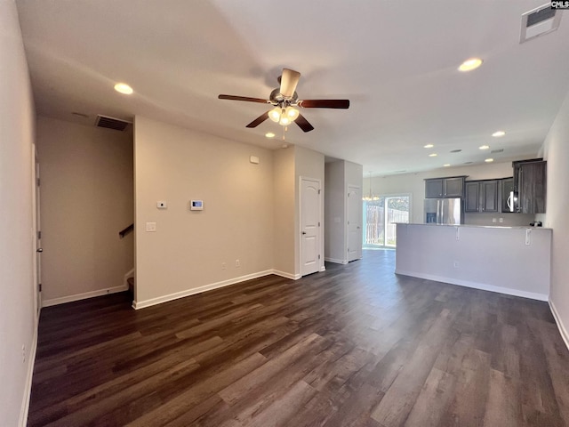 unfurnished living room with visible vents, a ceiling fan, dark wood finished floors, recessed lighting, and stairway