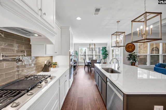 kitchen featuring a sink, stainless steel appliances, white cabinets, and dark wood-style flooring