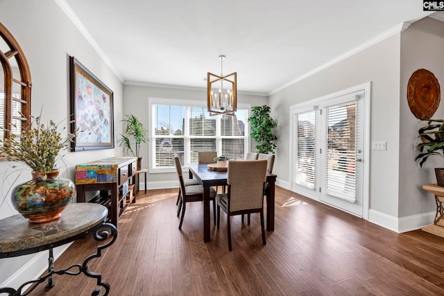 dining room with an inviting chandelier, crown molding, dark wood-style flooring, and baseboards