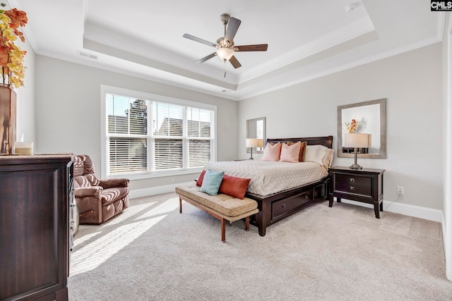 bedroom featuring light carpet, baseboards, and a tray ceiling