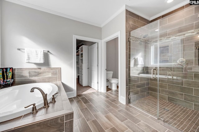 bathroom featuring a shower stall, a garden tub, and ornamental molding