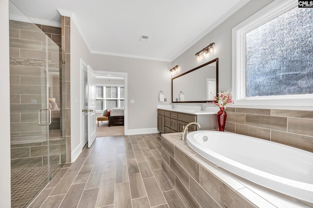 ensuite bathroom with double vanity, a shower stall, crown molding, a bath, and connected bathroom