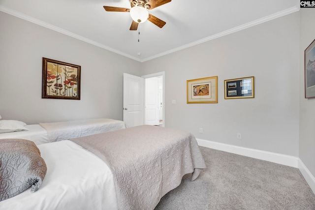 bedroom featuring crown molding, carpet flooring, baseboards, and ceiling fan