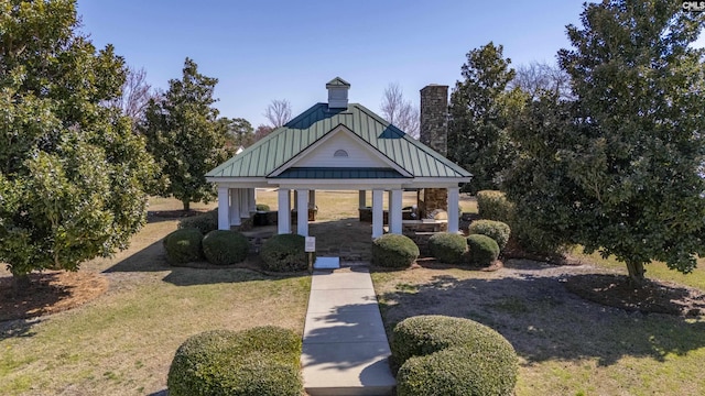 exterior space with a gazebo, a chimney, and a front yard