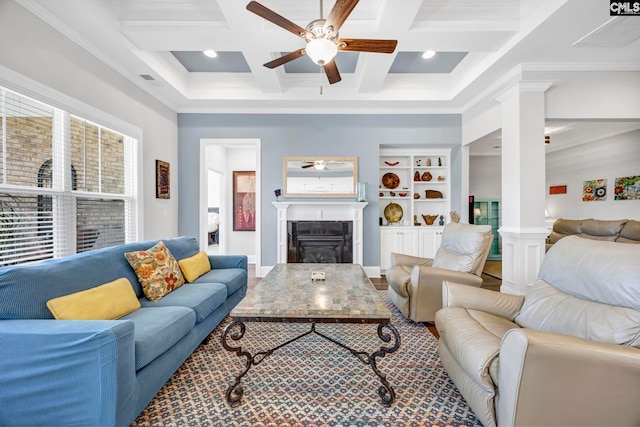 living area with beamed ceiling, coffered ceiling, a ceiling fan, and ornate columns