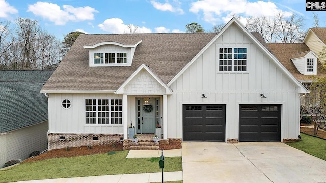 modern inspired farmhouse with a front lawn, board and batten siding, roof with shingles, concrete driveway, and a garage