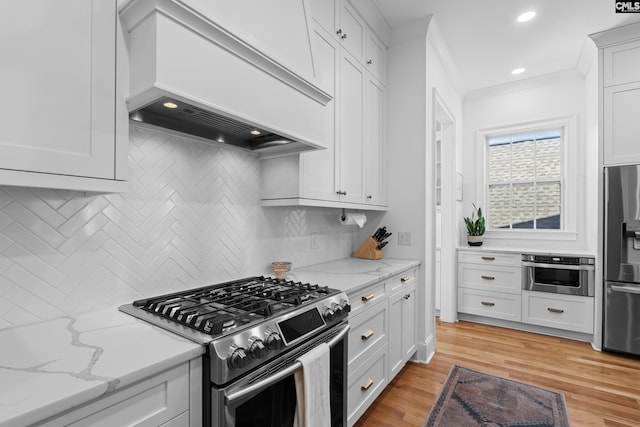 kitchen with tasteful backsplash, stainless steel appliances, crown molding, light wood finished floors, and custom exhaust hood