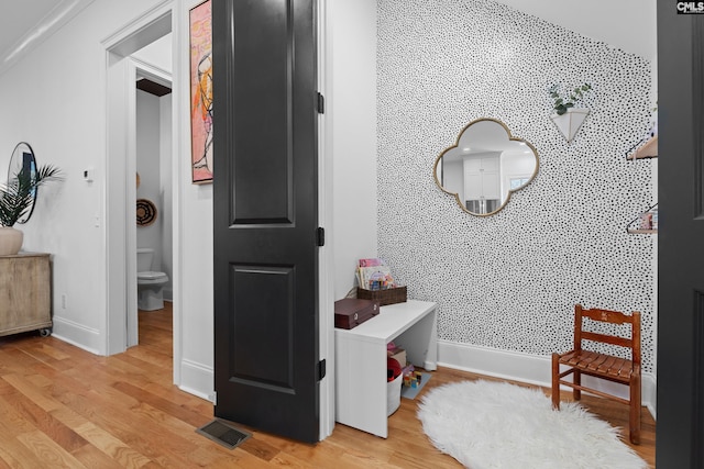 corridor with baseboards and light wood finished floors