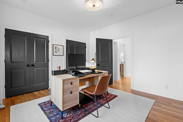 home office featuring baseboards and light wood-style flooring