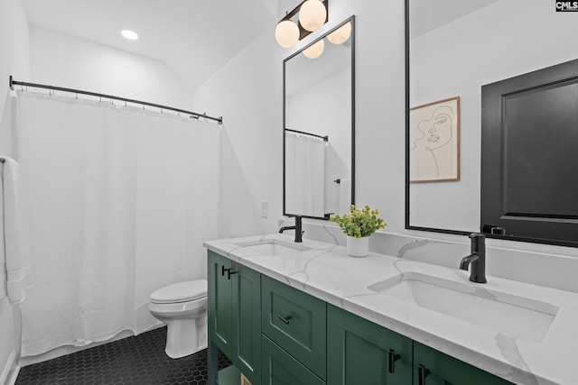 bathroom featuring double vanity, toilet, recessed lighting, and a sink