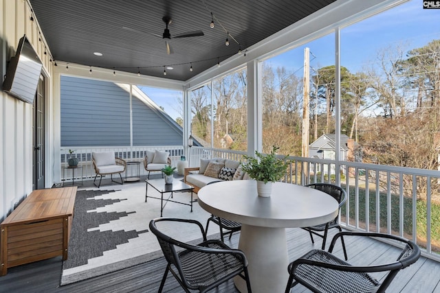 sunroom / solarium featuring a ceiling fan