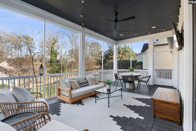 sunroom / solarium with rail lighting and ceiling fan