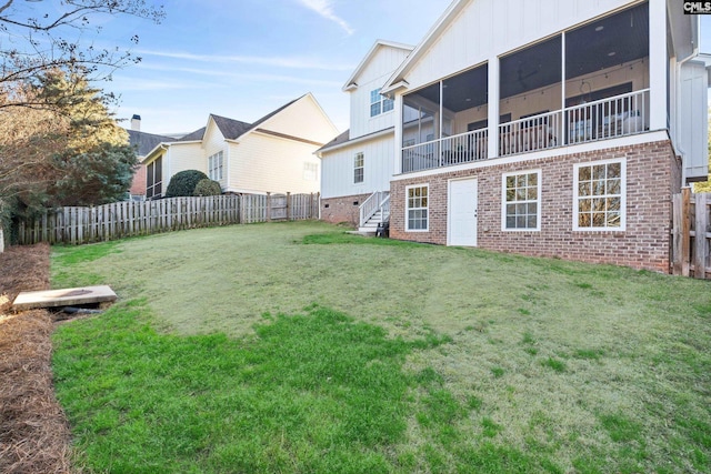 view of yard featuring a fenced backyard and a sunroom