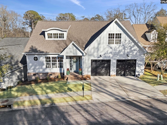 view of front facade featuring a front lawn, driveway, board and batten siding, a shingled roof, and crawl space