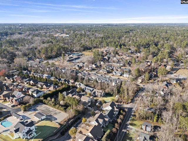 bird's eye view featuring a forest view and a residential view