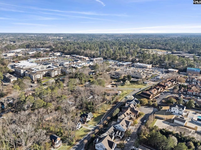 birds eye view of property featuring a view of trees